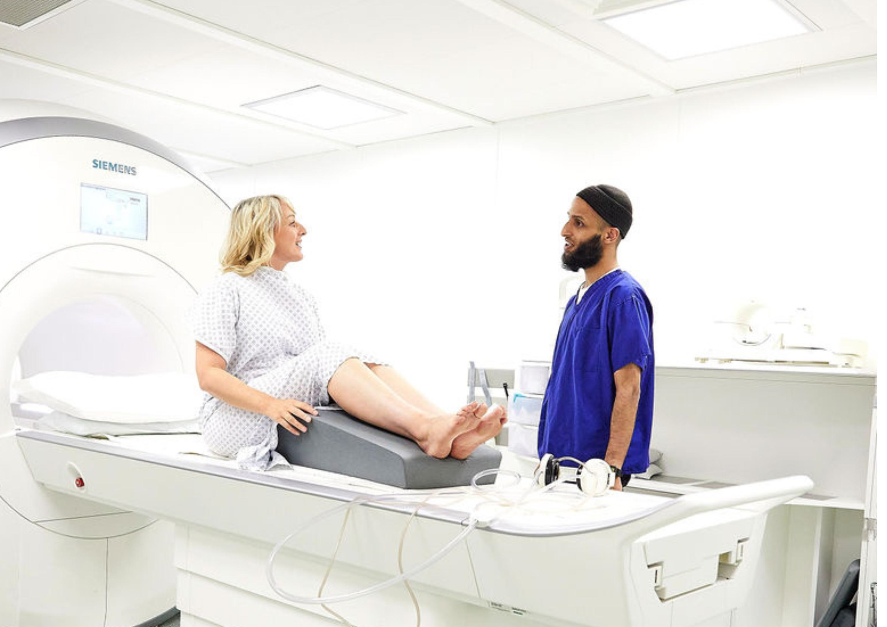 a woman on an MRI talking to a Radiologist a woman on an MRI talking to a Radiologist